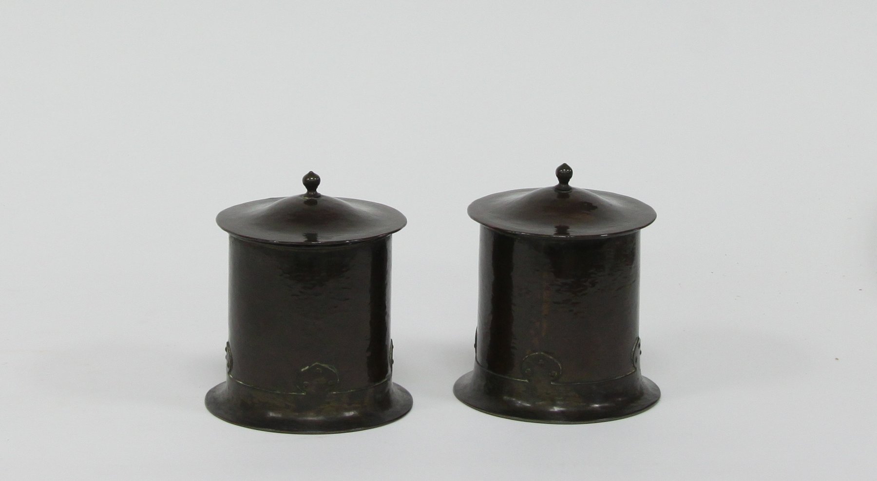 Appraisal: A pair of copper cylindrical jars and covers by A