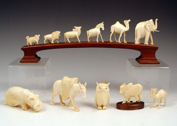 Appraisal: CARVED IVORY ANIMALS An animal bridge of from the hyena