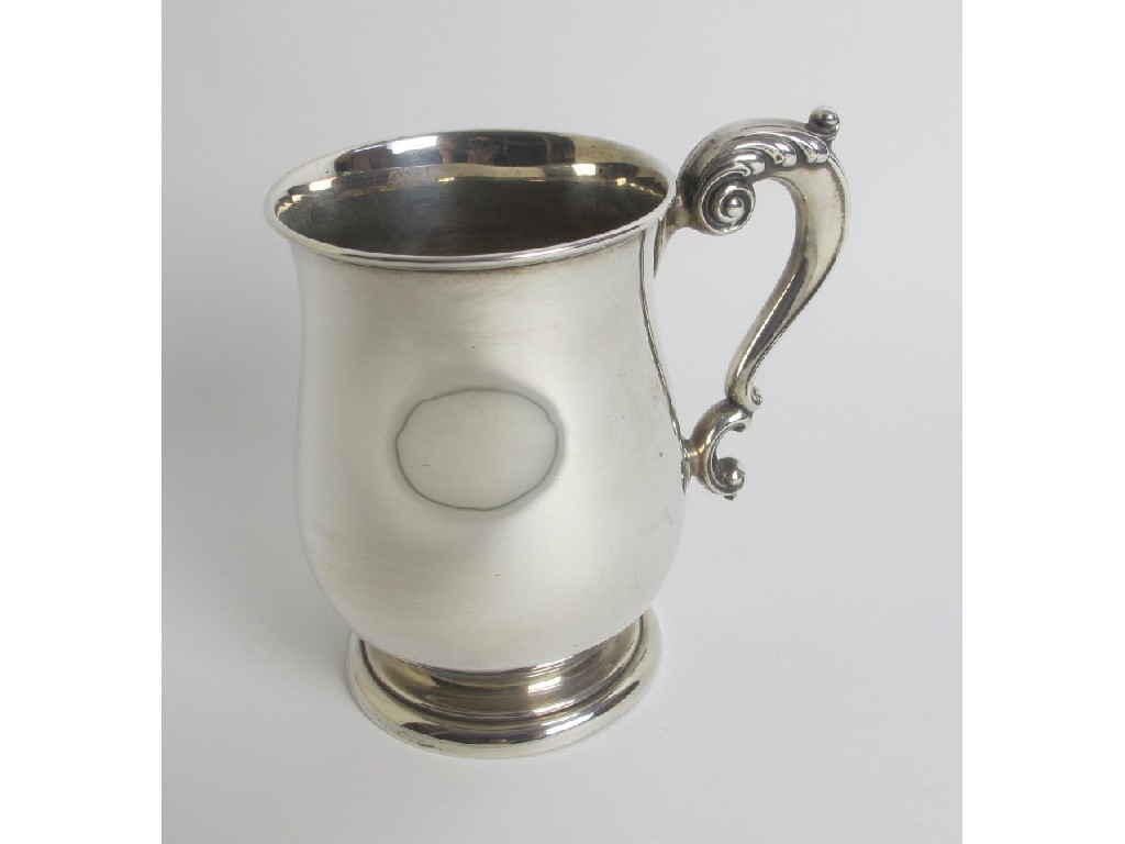 Appraisal: A silver tankard of baluster form with double C scroll