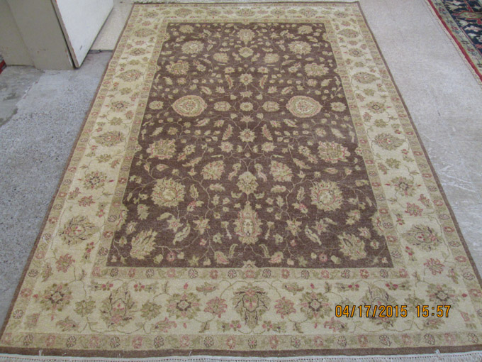 Appraisal: HAND KNOTTED ORIENTAL CARPET Indo-Persian overall floral design on brown