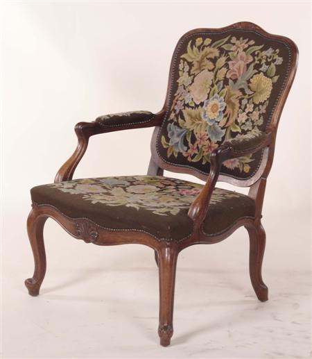 Appraisal: A Louis XV style walnut fauteuil the shaped back over