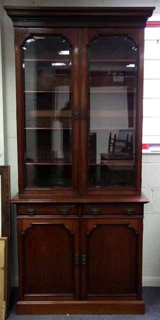 Appraisal: An Edwardian mahogany bookcase circa with dentil frieze above two