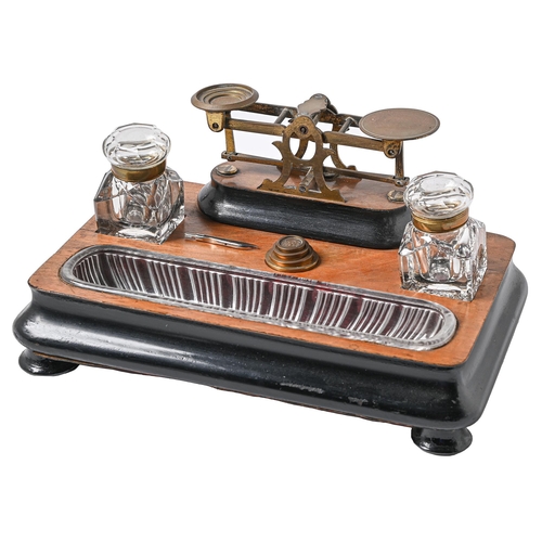 Appraisal: A Victorian walnut and ebonised inkstand incorporating brass postal balance