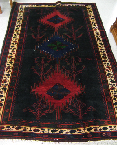 Appraisal: PERSIAN ILATI TRIBAL CARPET centering a column of three geometric