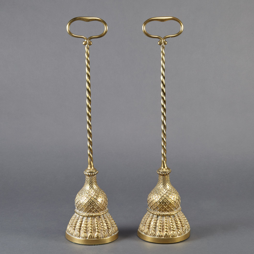 Appraisal: Two Brass Door Stops Each with a handle above a