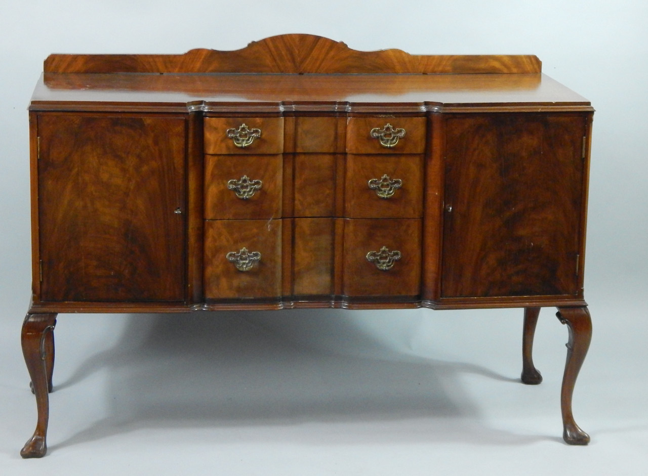 Appraisal: An Edwardian flame mahogany break front sideboard with three frieze