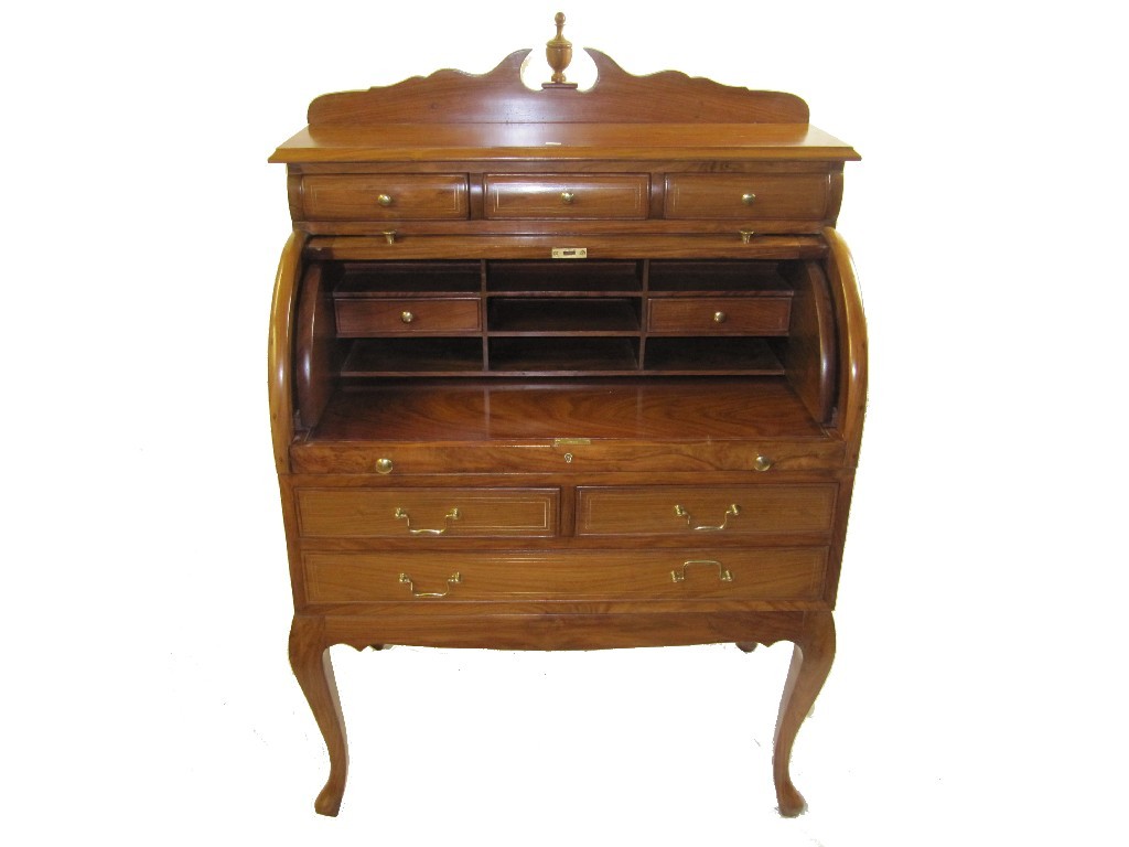 Appraisal: A reproduction cylinder shaped writing bureau raised on a rectangular