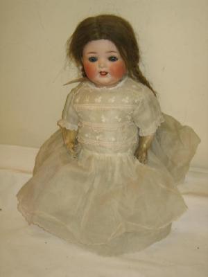 Appraisal: A Heubach bisque head girl character doll with blue glass