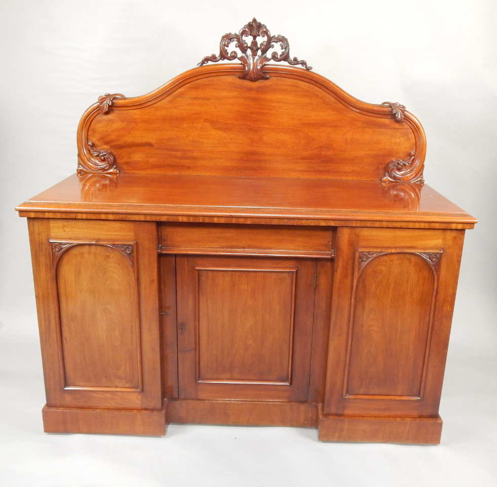 Appraisal: A Victorian mahogany sideboard the leaf scroll back over a