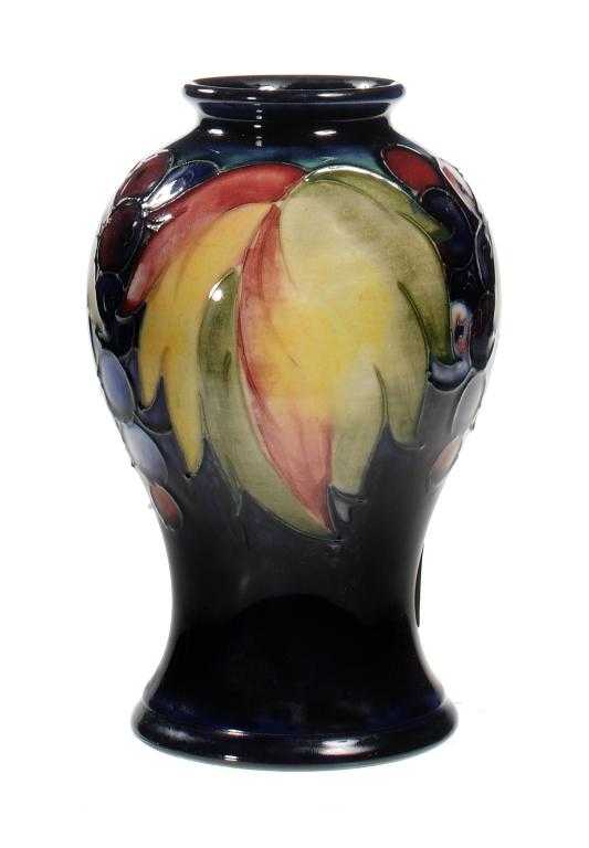 Appraisal: A MOORCROFT LEAF AND GRAPE VASE DESIGNED BY WILLIAM MOORCROFT