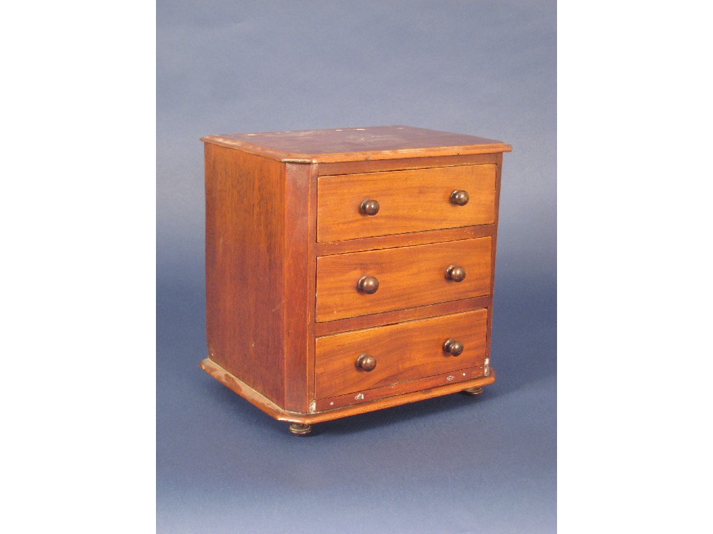 Appraisal: A Victorian miniature Chest of three drawers on turned feet