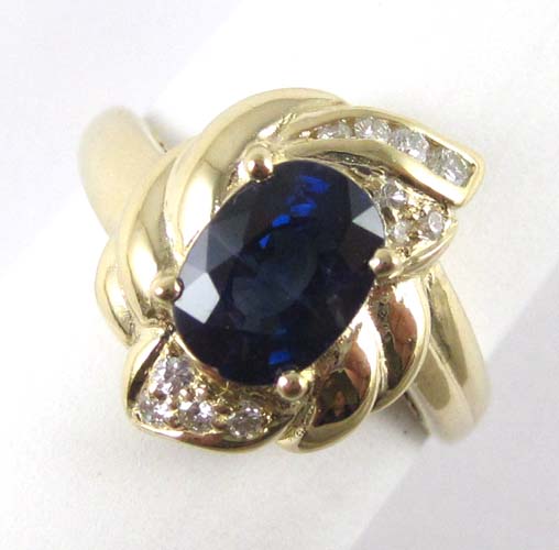 Appraisal: SAPPHIRE DIAMOND AND FOURTEEN KARAT GOLD RING centering an oval