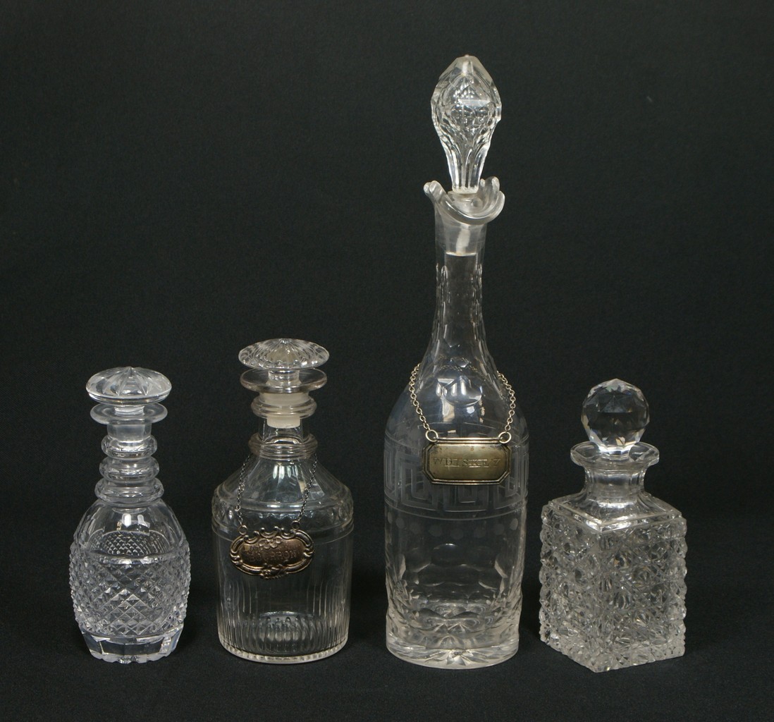 Appraisal: engraved cut crystal decanters with ground stoppers tallest repaired stopper