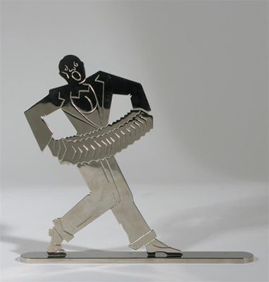 Appraisal: An Austrian silvered metal figure of an accordian player on