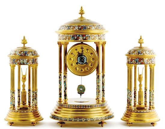 Appraisal: Exceptional French champleve enamel clock garniture circa floral finial atop