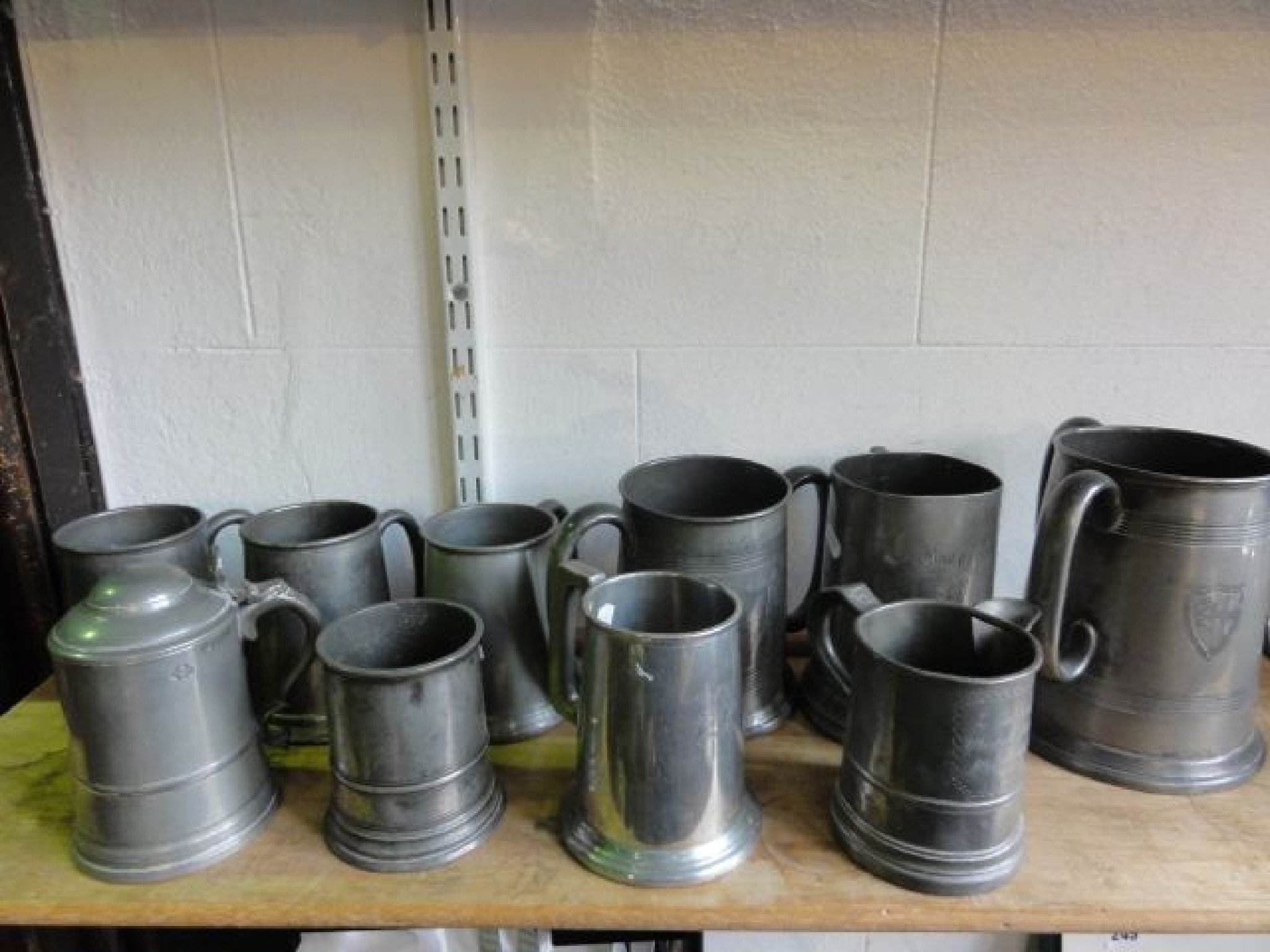 Appraisal: A collection of antique pewter tankards to include a large