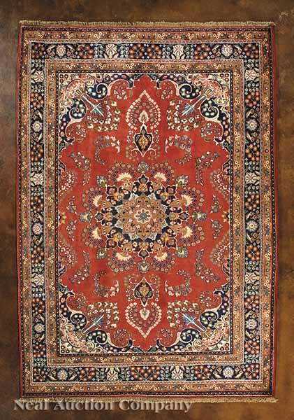 Appraisal: A Persian Tabriz Carpet red brown and blue ground central