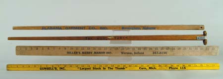 Appraisal: NINE YARDSTICKS All wood One square Alabama Garment Company CONDITION