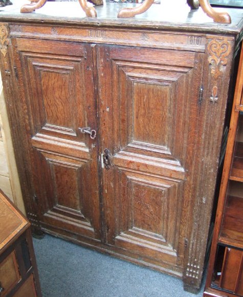 Appraisal: An th century oak small two door cabinet with moulded