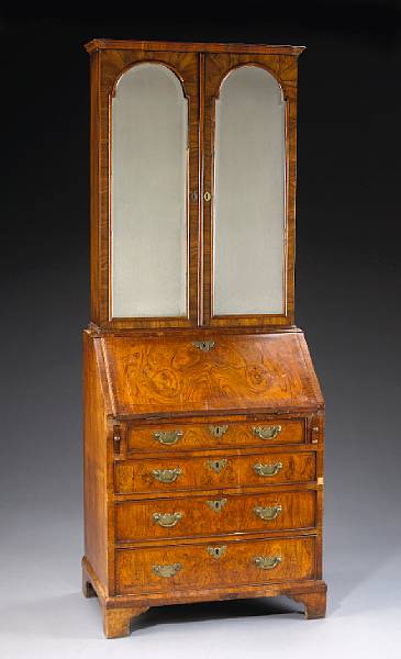 Appraisal: A diminutive George I walnut secretary bookcase early th century