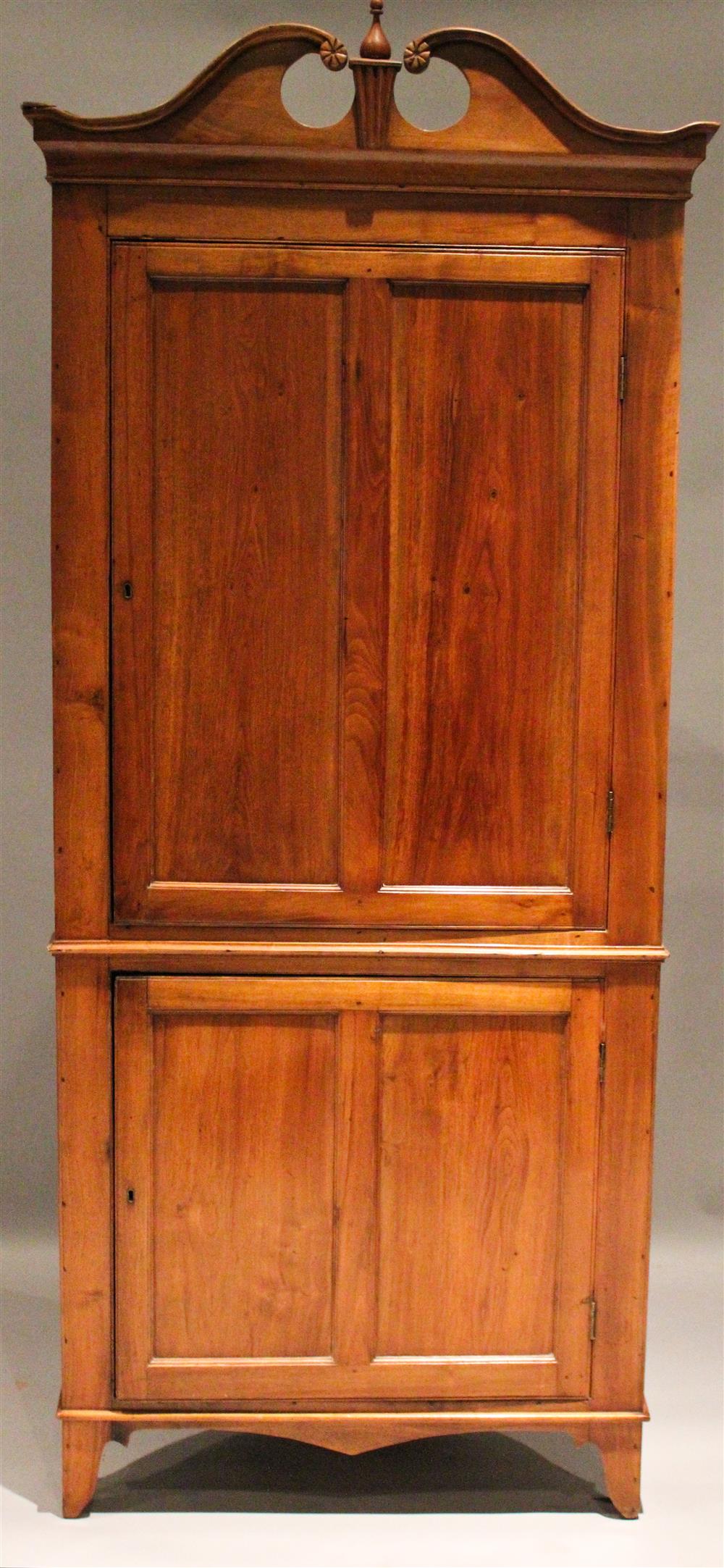 Appraisal: SOUTHERN WALNUT CORNER CUPBOARD WITH SCROLLED PEDIMENT AND TURNED FINIAL