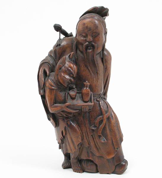 Appraisal: A Chinese bamboo carving of an immortal with a demon