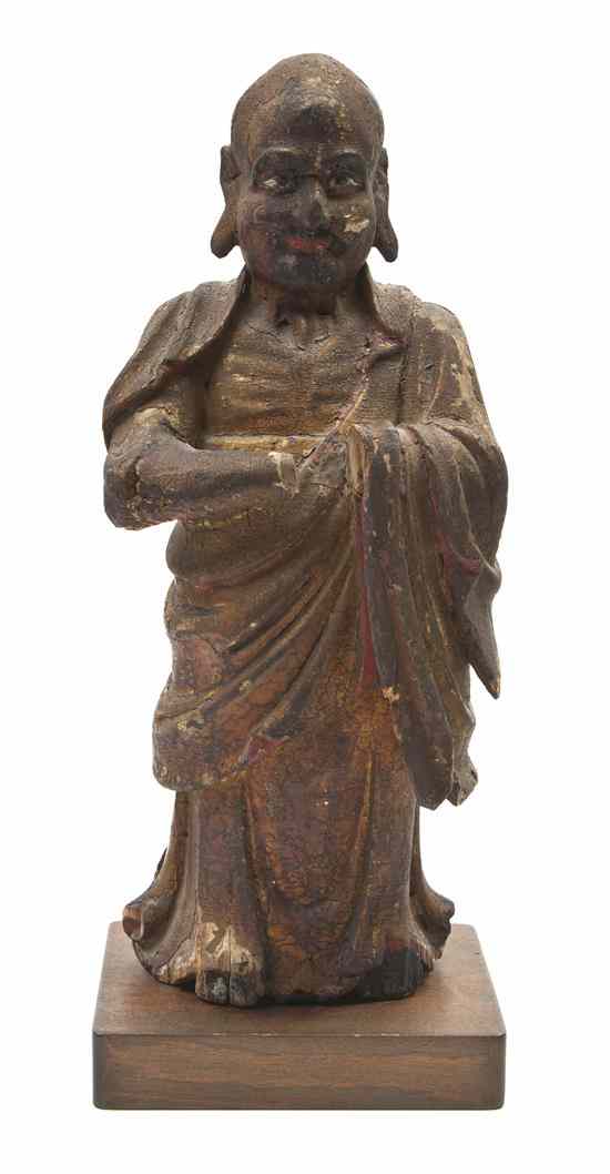 Appraisal: A Chinese Gesso and Wood Statue depicting a robed Buddhist