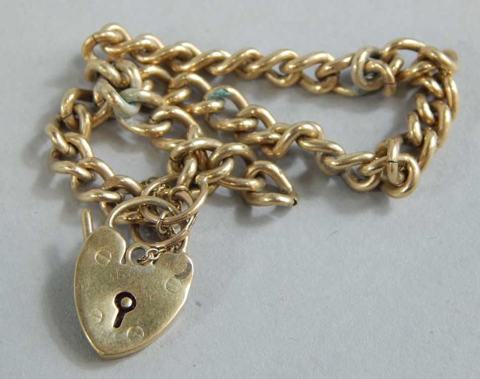 Appraisal: A ct gold charm bracelet on curb link chain with