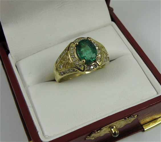 Appraisal: EMERALD DIAMOND AND K GOLD RING centering an oval-cut green