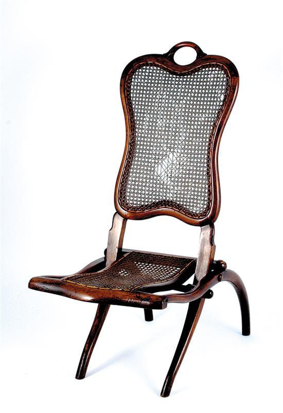 Appraisal: Victorian cane and walnut folding lawn chair circa shaped back