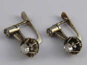 Appraisal: A pair of white metal tests carat gold diamond earrings