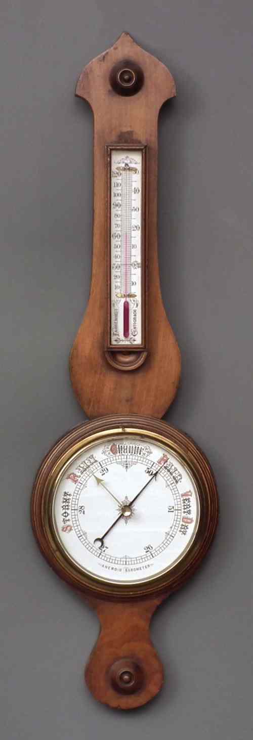 Appraisal: A Victorian walnut cased aneroid barometer and thermometer with ins