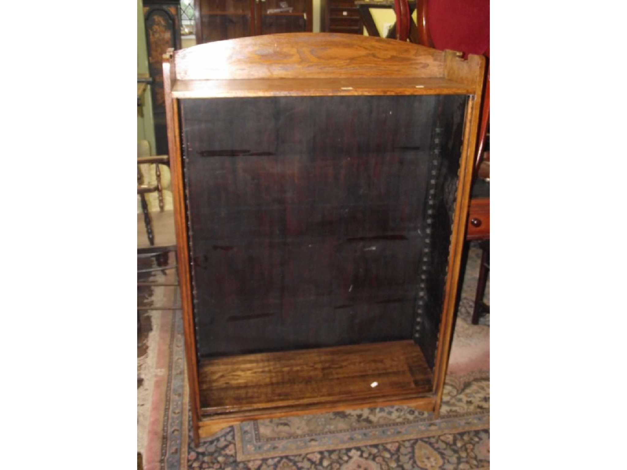 Appraisal: An arts and crafts oak bookcase of simple form fitted