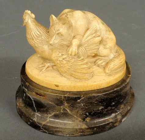 Appraisal: Carved ivory fox with chicken mounted on a marble base