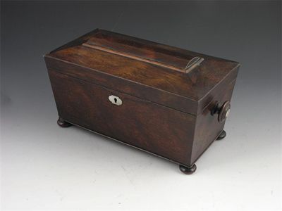 Appraisal: A Victorian rosewood tea caddy with a pair of domed