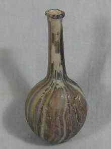 Appraisal: A small glass bottle of striated variegated brown glass probably