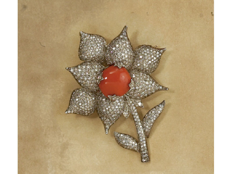 Appraisal: DIAMOND AND CORAL BROOCH Silver floral design brooch centering one