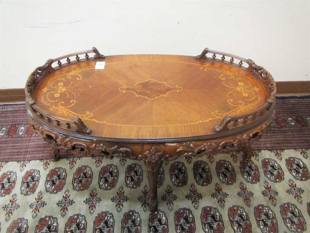 Appraisal: CARVED AND INLAID COFFEE TABLE Louis XV style American mid-