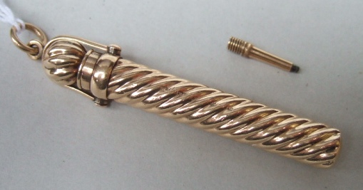 Appraisal: A ct gold cased propelling pencil the exterior with spiral