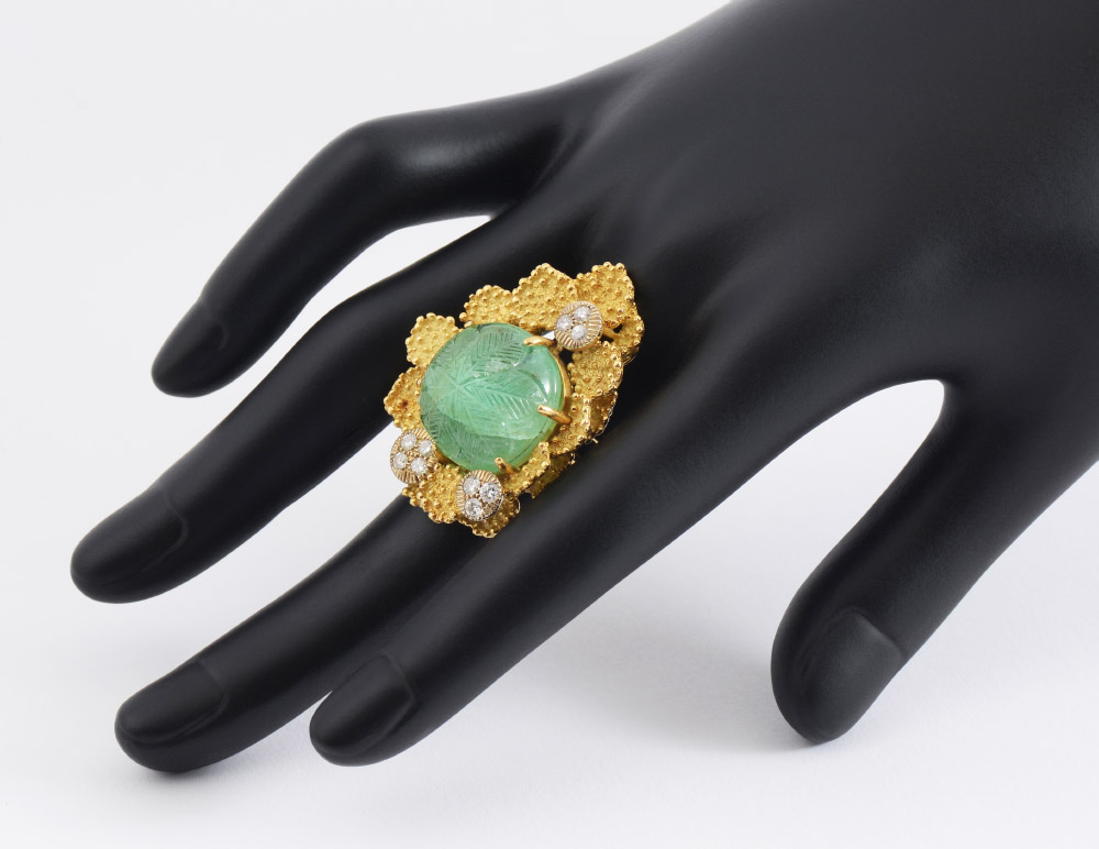 Appraisal: K CARVED EMERALD AND DIAMOND RING A sculptural K yellow