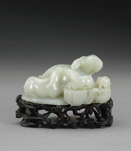 Appraisal: A carved white jade carving of a ram group th