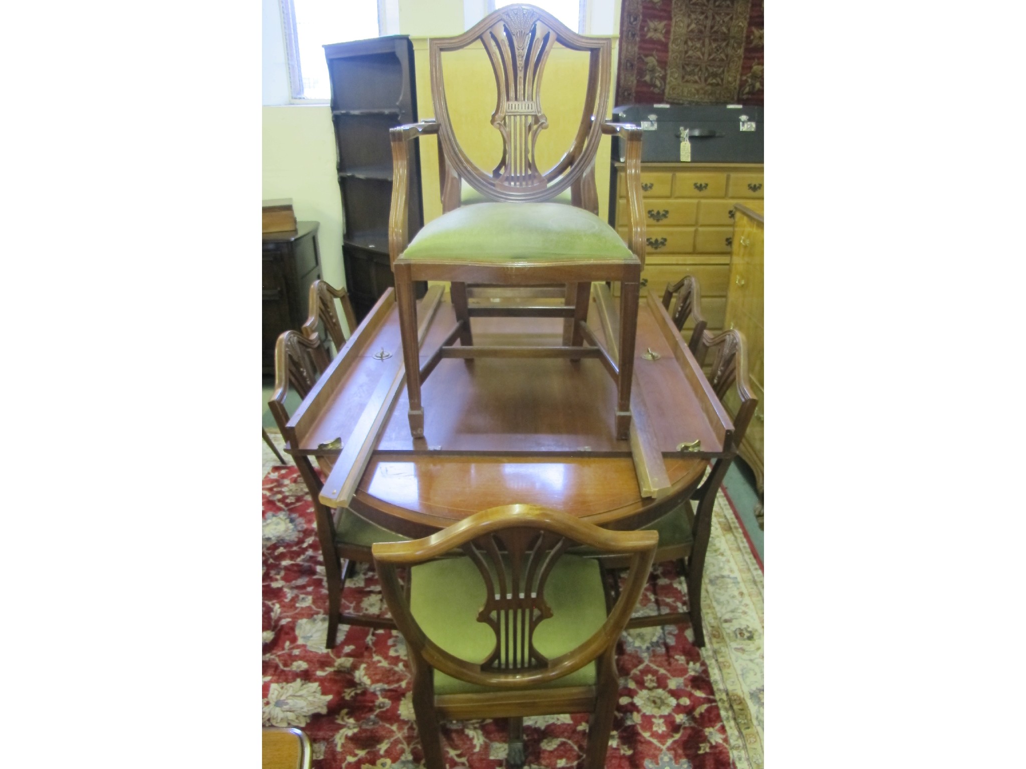 Appraisal: An inlaid dual extending dining table with shield back chairs