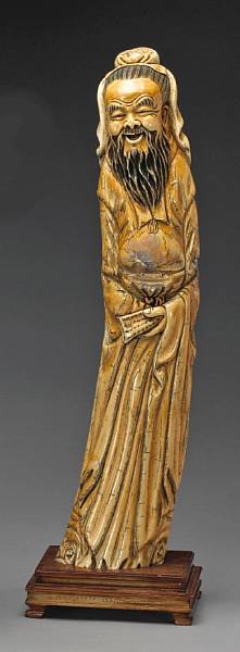 Appraisal: A large stained ivory figure of a scholar th Century