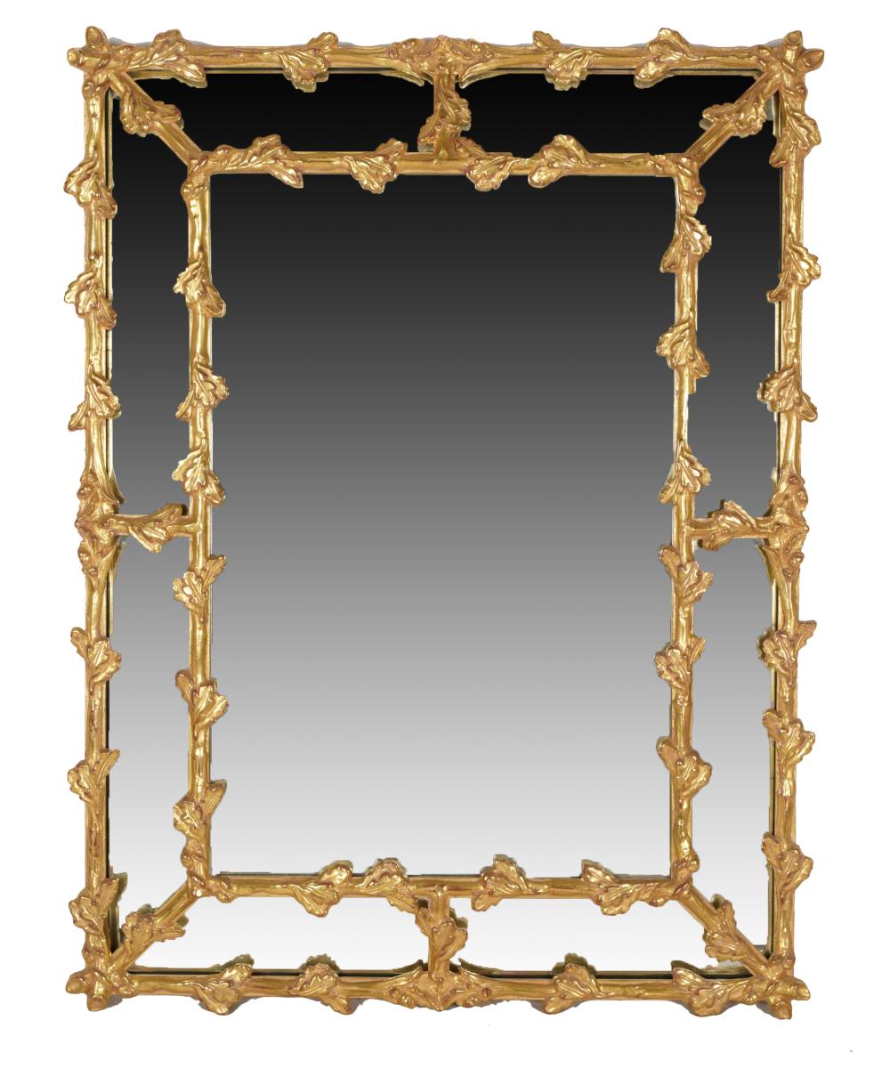 Appraisal: CARVED GILTWOOD WALL MIRRORthe flat plate within angled marginal plates