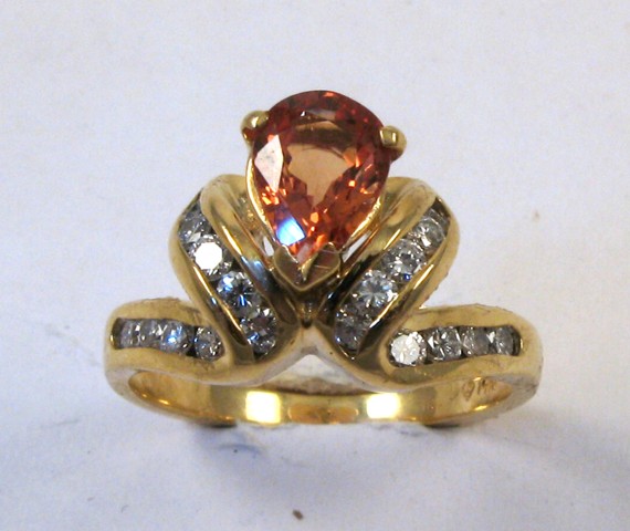 Appraisal: ORANGE SAPPHIRE AND DIAMOND RING k yellow gold set with