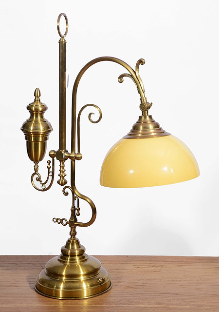 Appraisal: A BRASS READING LAMP of open scroll form with counter