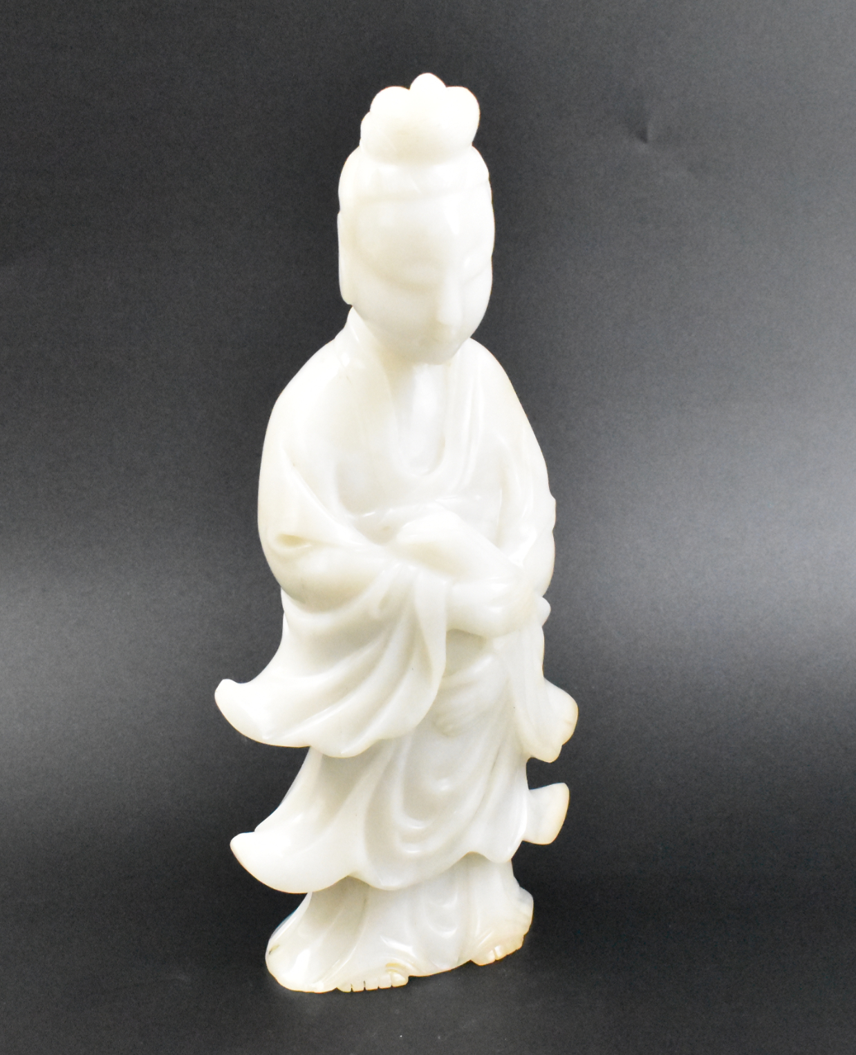 Appraisal: A Chinese Jade carved Guanyin figure The standing figure has