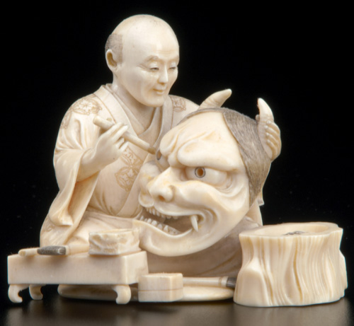 Appraisal: JAPANESE IVORY Carved okimono of an artisan painting a mask