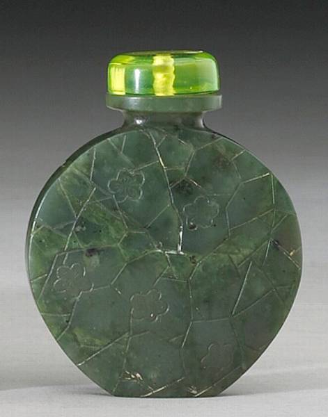 Appraisal: A circular 'spinach' nephrite snuff bottle th Century The well