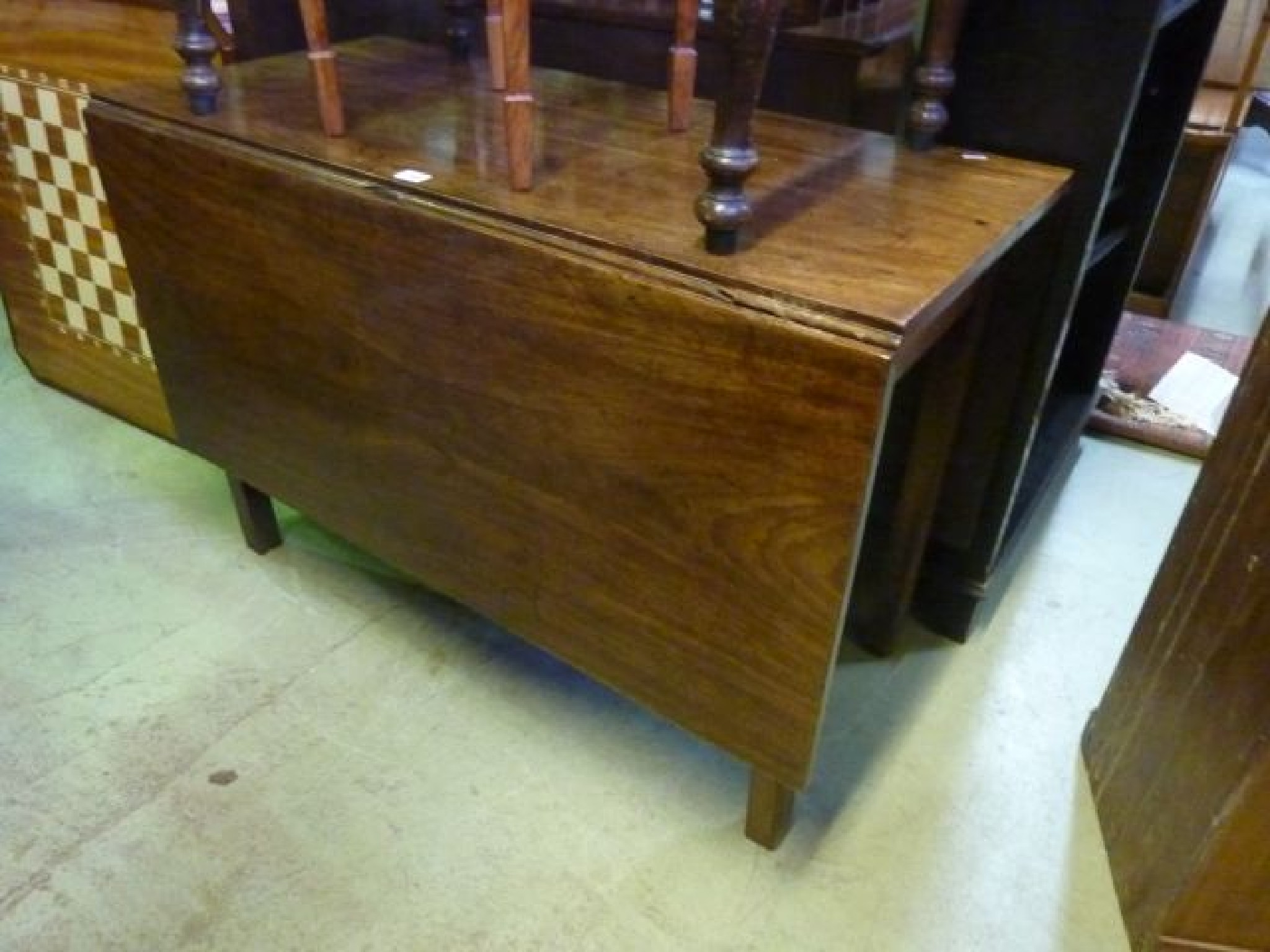 Appraisal: A Georgian mahogany drop leaf dining table raised on four